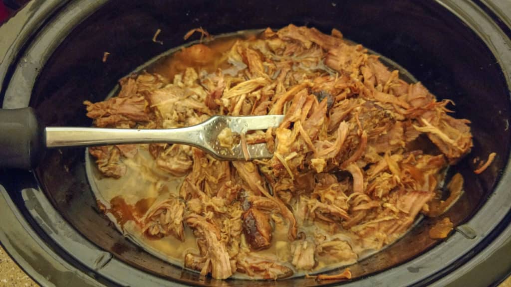 fully cooked pork carnitas in a crockpot