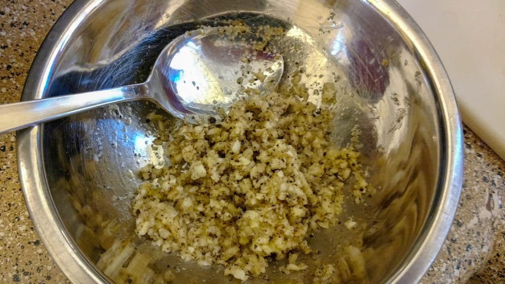 bowl of garlic and herbs rub for pork carnitas