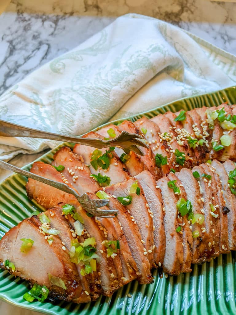 Chinese BB Pork fanned out on a green leaf platter