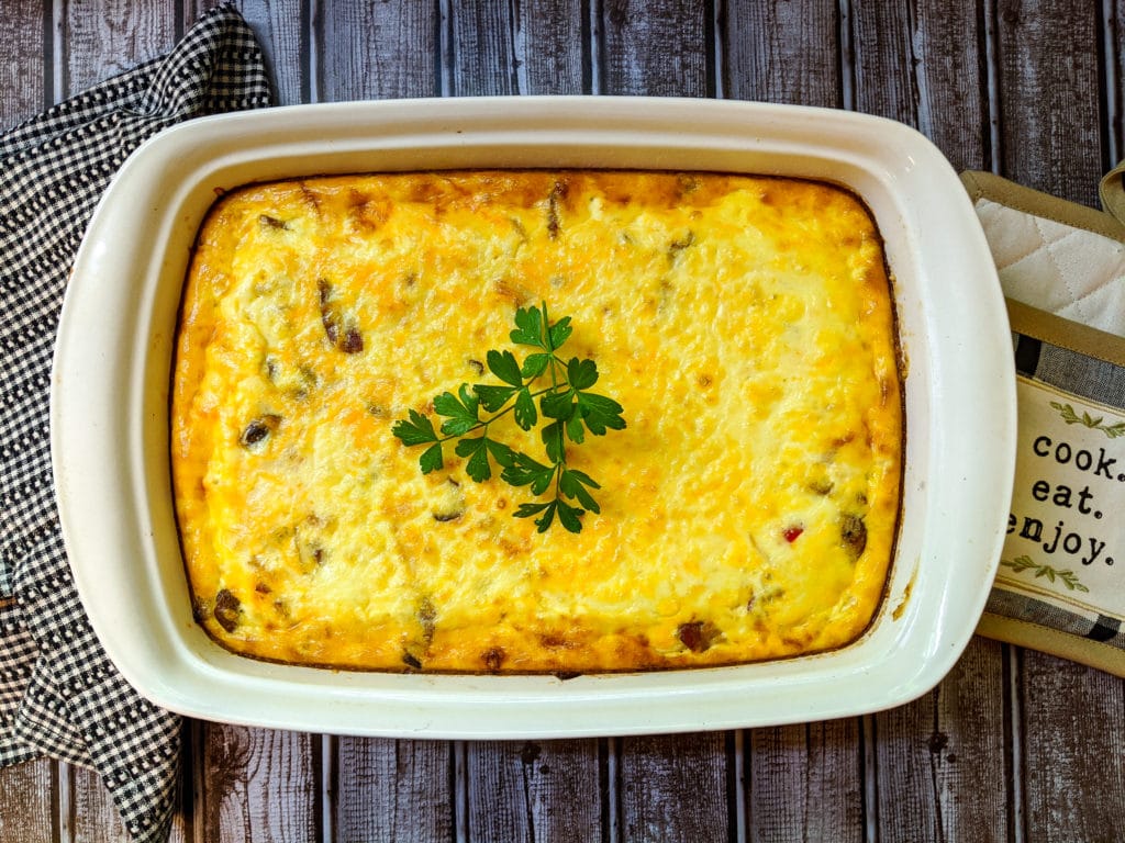 Cooked pan of quiche with garnish