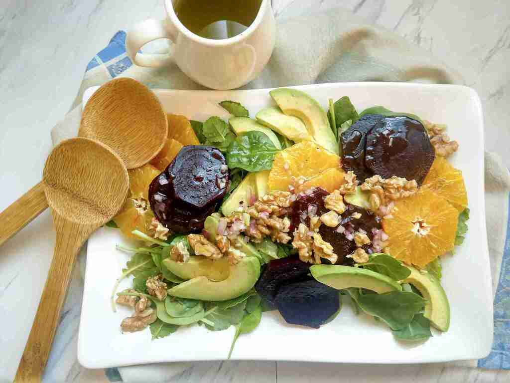 Orange and beet salad with avocado on a serving platter