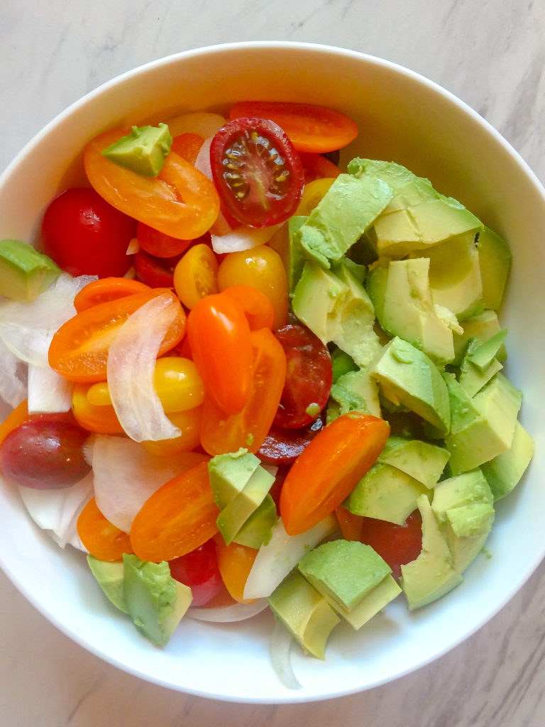 Tomato, Avocado and Sweet Onion Salad in a bowl