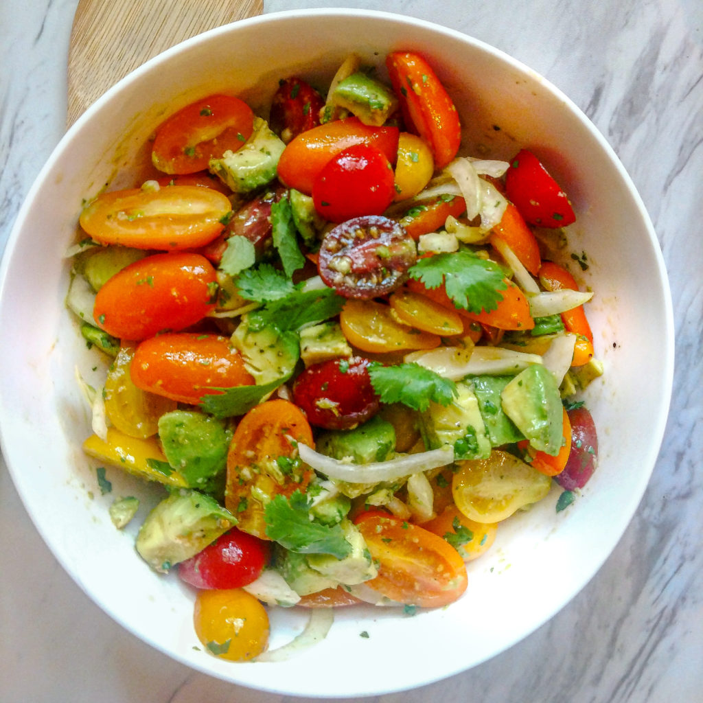 Tomato, Avocado and Sweet Onion Salad in a white serving bowl