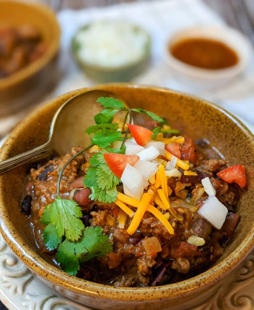simple weeknight chili in a bowl with toppings