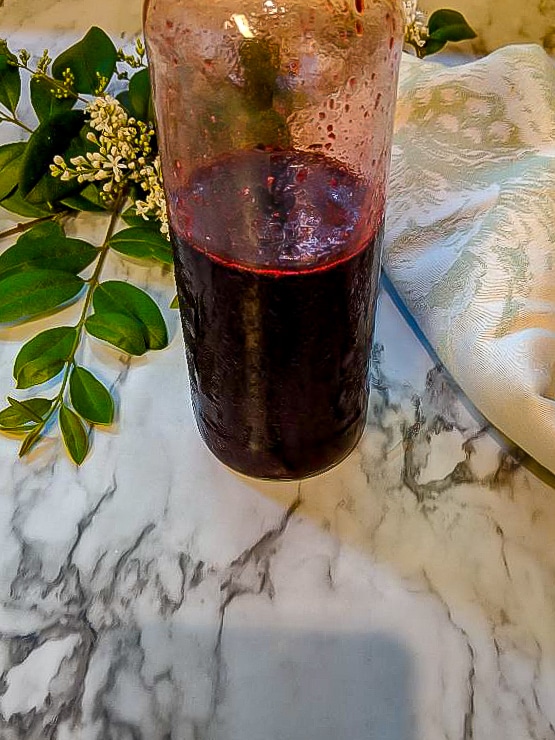 A bottle of syrup on a table