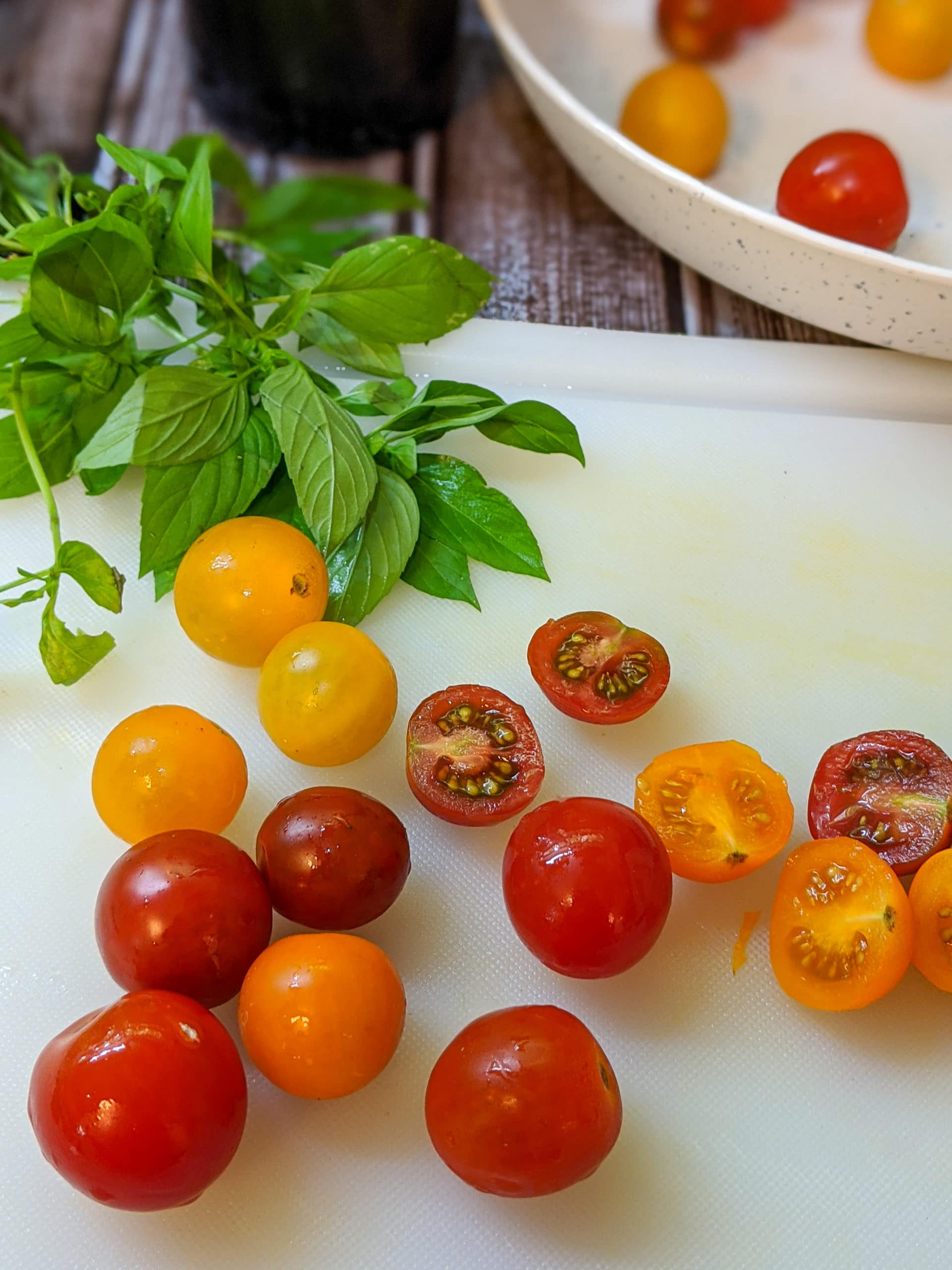 tomatoes and basil on cutting board
