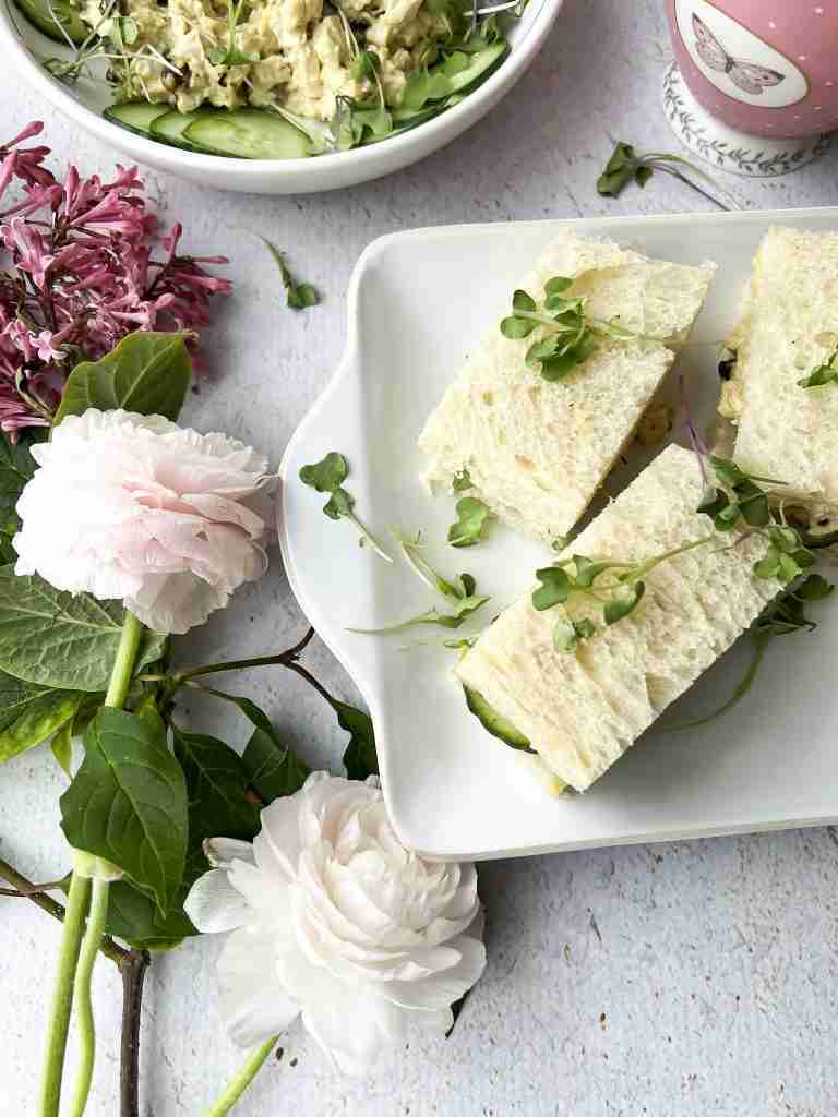 Coronation chicken finger sandwiches on a white platter