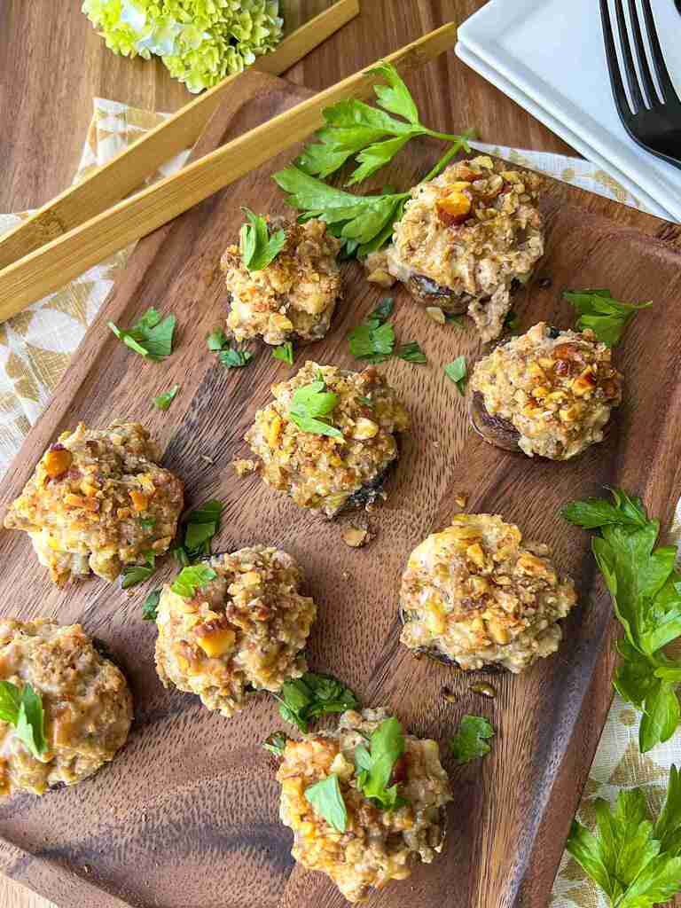 Sausage Stuffed Mushrooms on a wood serving tray