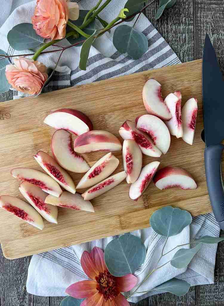 Sliced peaches on a cutting board