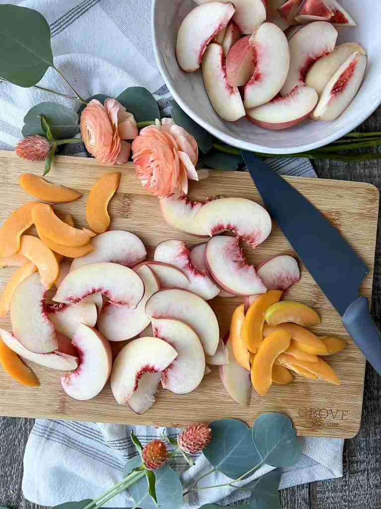 Sliced peaches and apricot on a cutting board